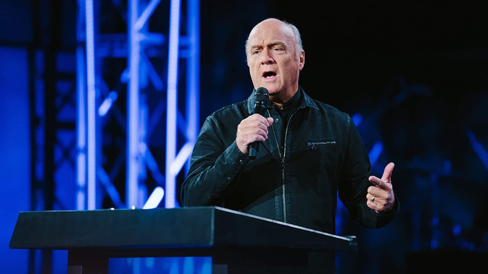Greg Laurie on stage preaching All Things