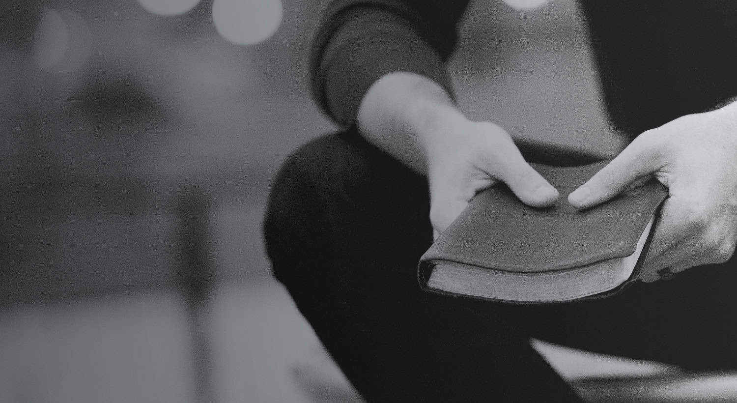 Background image of person holding a Bible