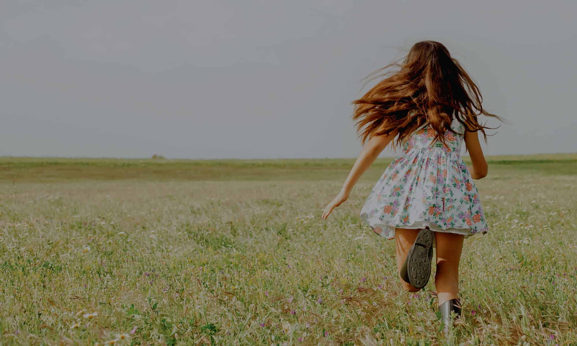 Woman running freely in field