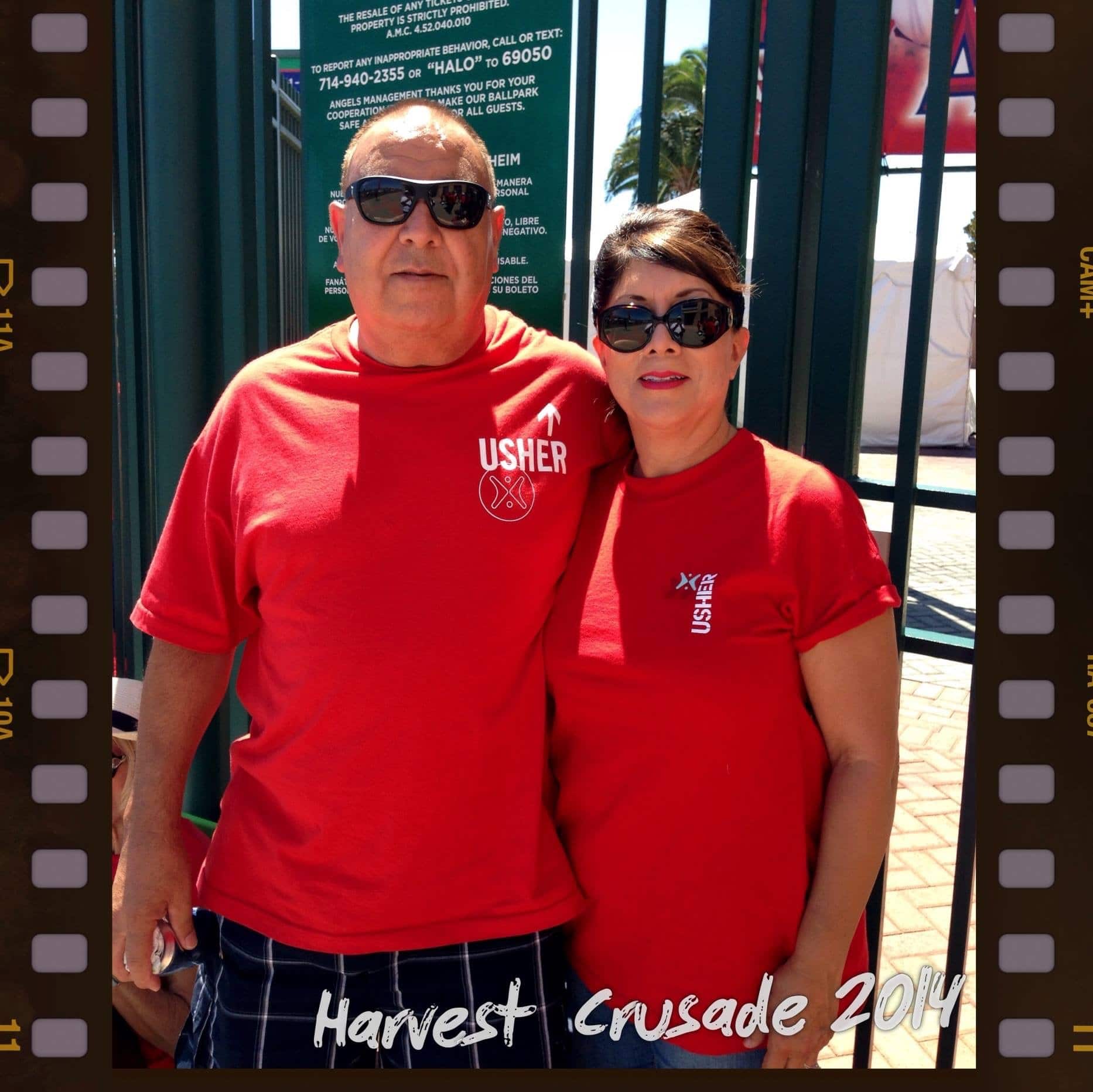 man and woman embracing for picture with red shirts outside gate at angels stadium harvest so cal 2019 satruday night