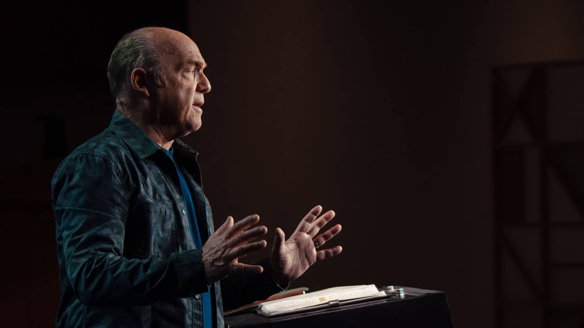 Pastor Greg Laurie preaches at a pulpit