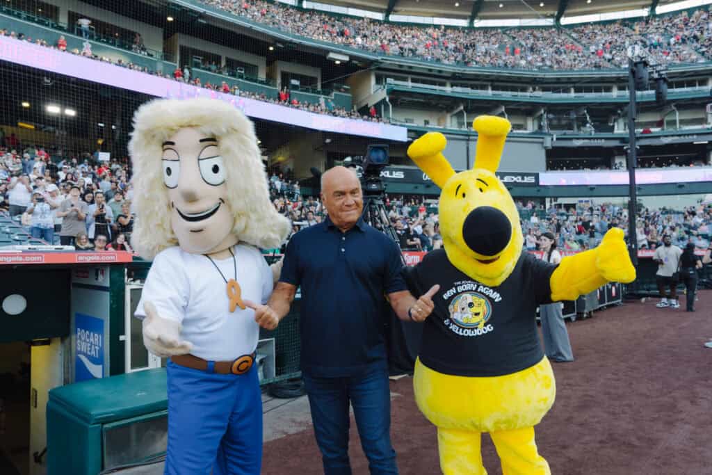 Greg Laurie with Ben Born Again and YellowDog cartoon characters at the 2024 Harvest Crusade