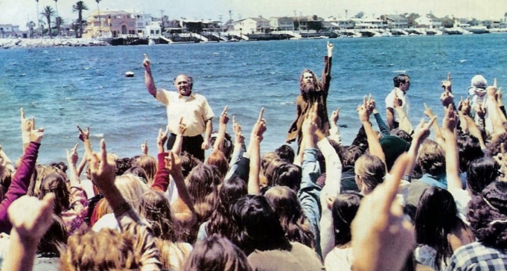 Chuck Smith and Lonnie Frisbee baptize at Pirate's Cove Beach