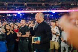 greg laurie with 2024 harvest crusade audience on field at angel stadium