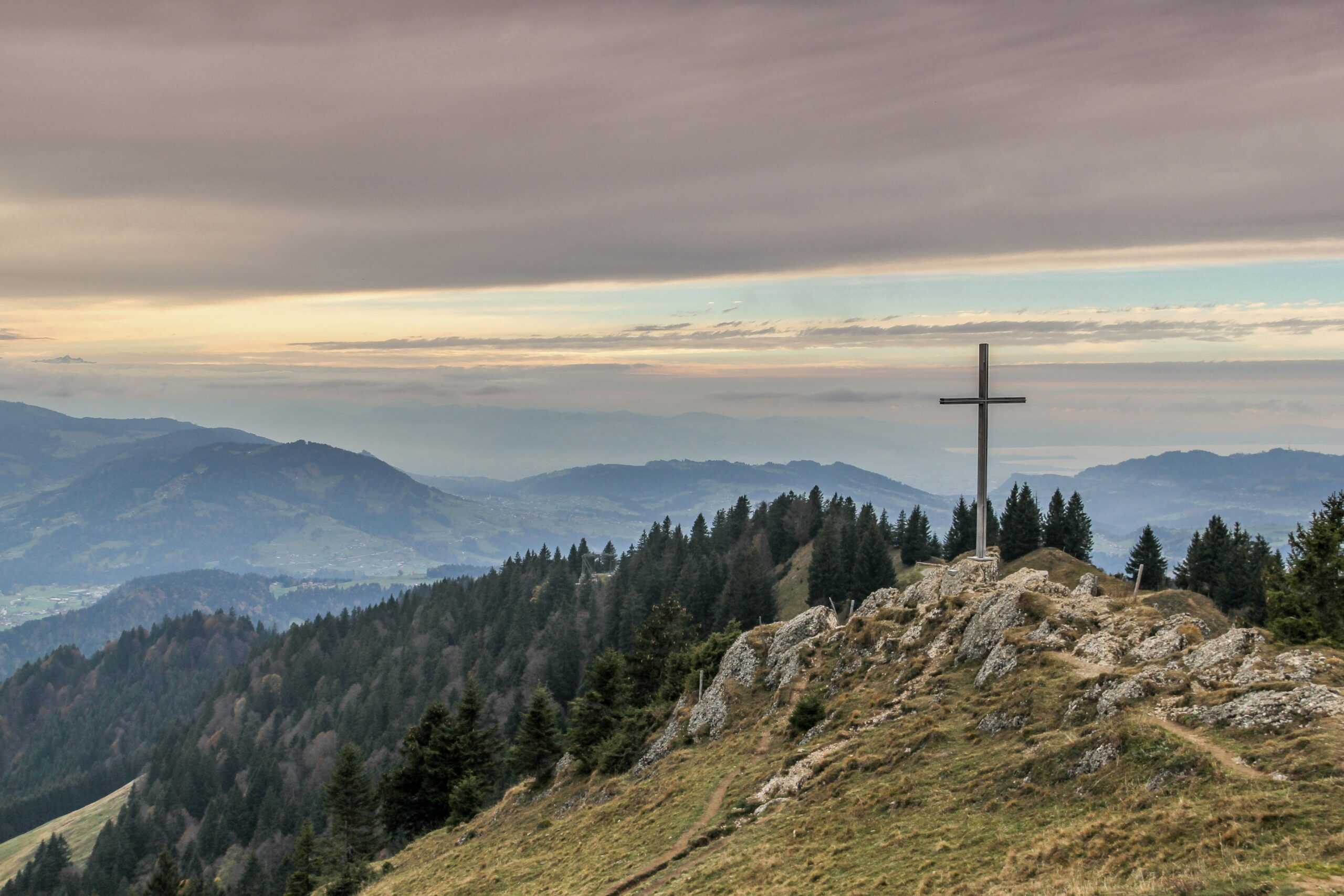 Cross sitting on mountain